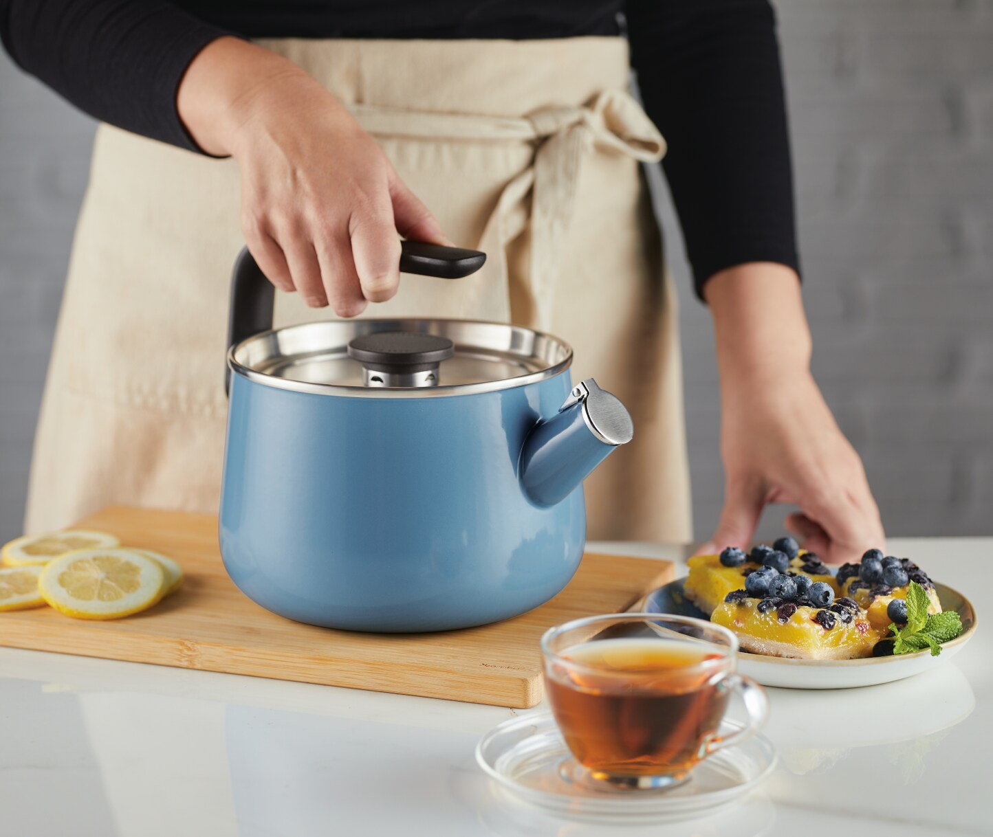 Person brewing hot water for tea with a KitchenAid® Stovetop Kettle.