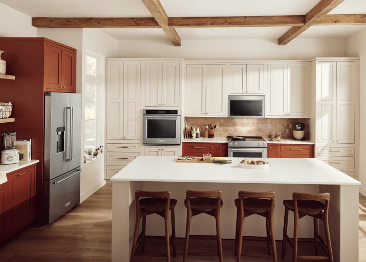 A southwest kitchen with warm cabinetry, stainless steel KitchenAid® appliances and natural textures throughout.