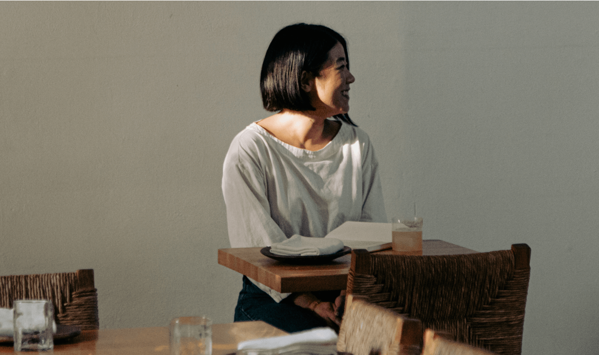 Ethaney Lee at a table in Oaxaca with her personal notebook.
