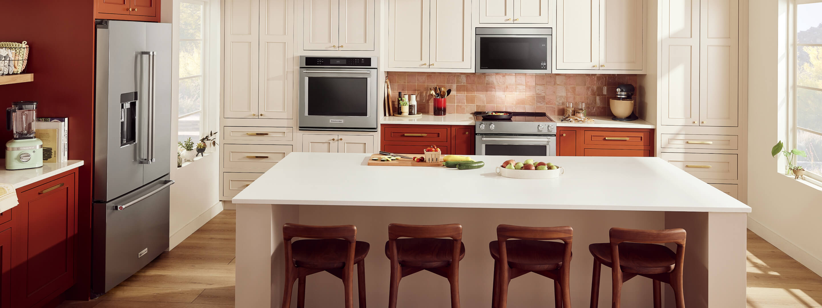 A modern, natural kitchen with KitchenAid® major and countertop appliances installed.