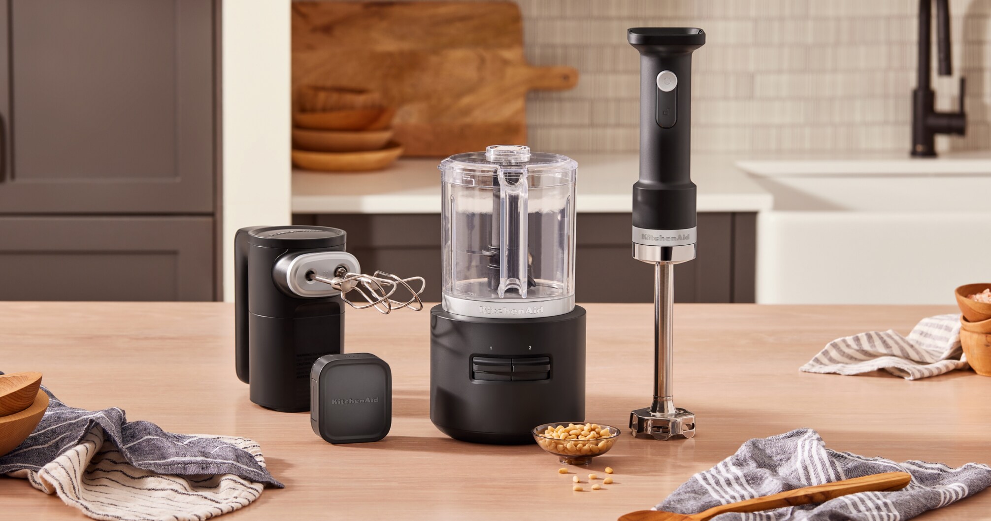 KitchenAid Go™ Cordless Hand Mixer, Food Chopper, Hand Blender and Battery on a countertop.