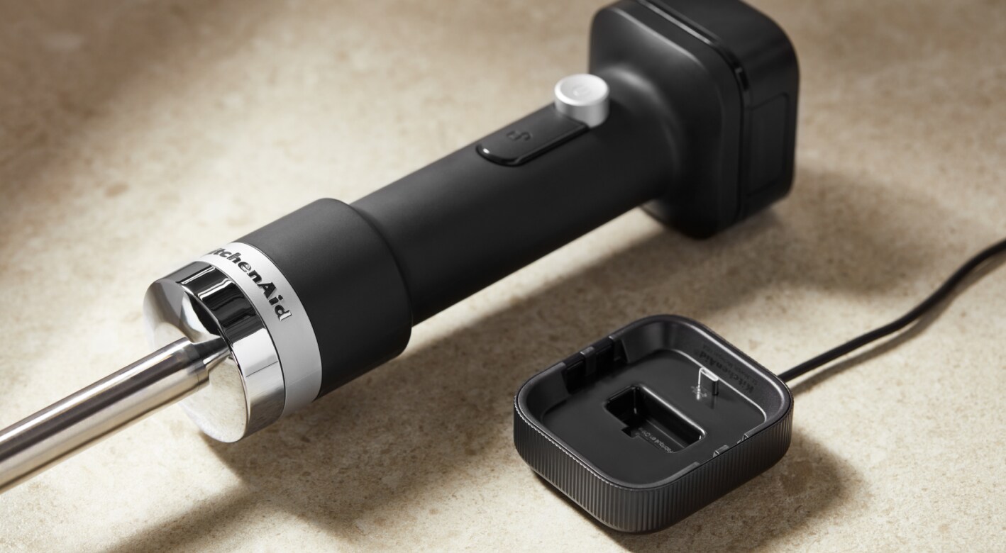 KitchenAid Go™ Cordless Hand Blender next to the charging dock.