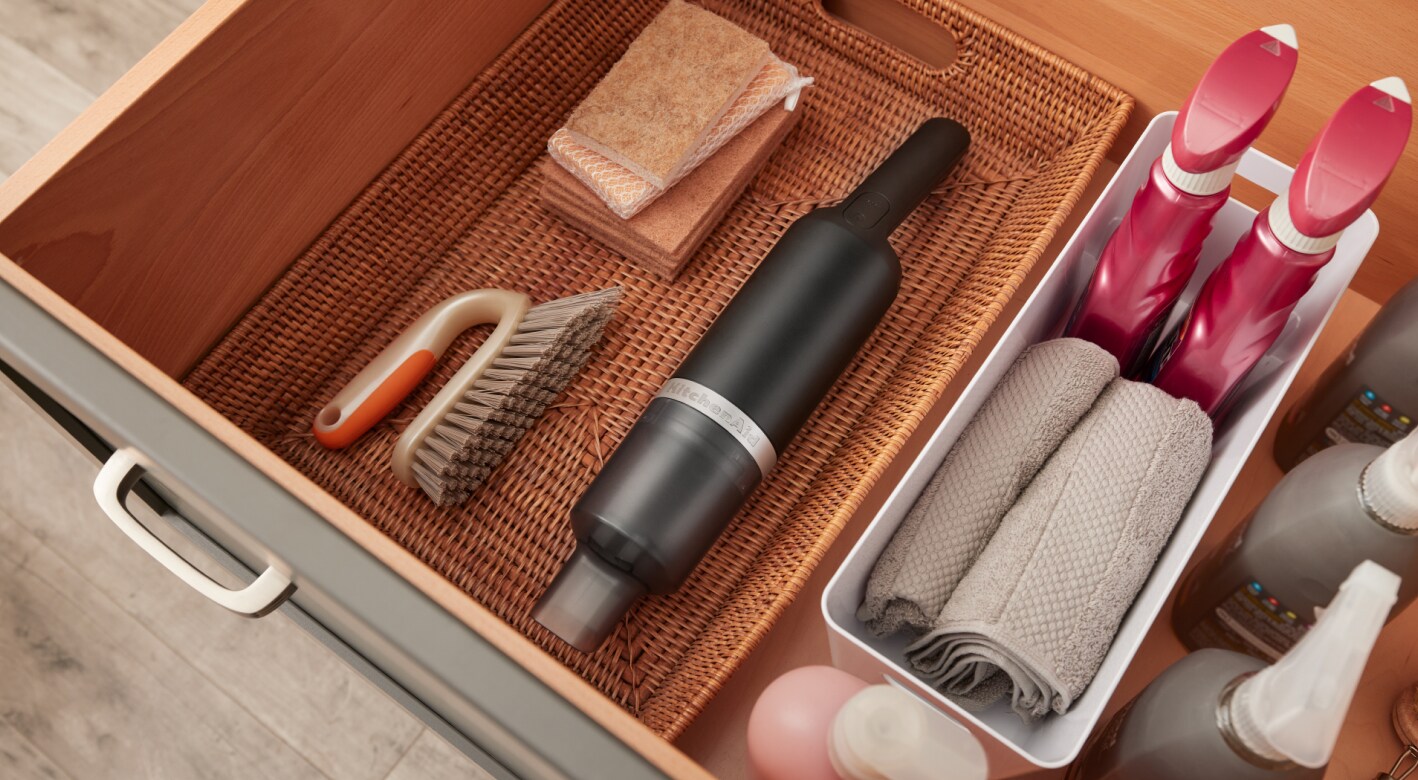 KitchenAid Go™ Cordless Kitchen Vacuum in a basket in a drawer.