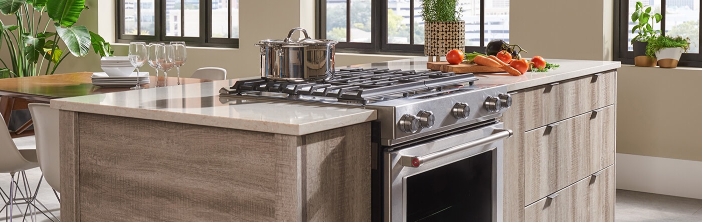 Kitchen island with slide-in range