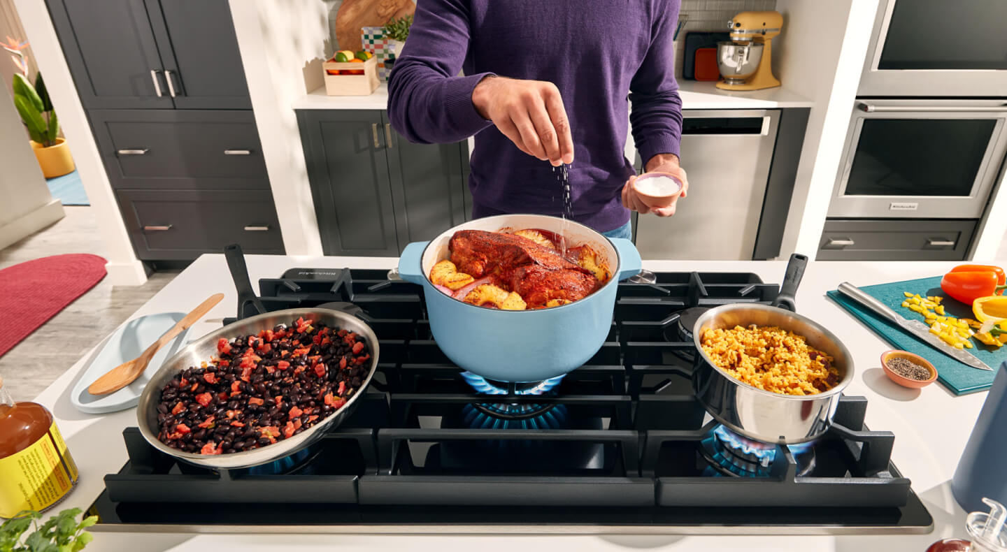 Person cooking on a gas range Person cooking on a gas range