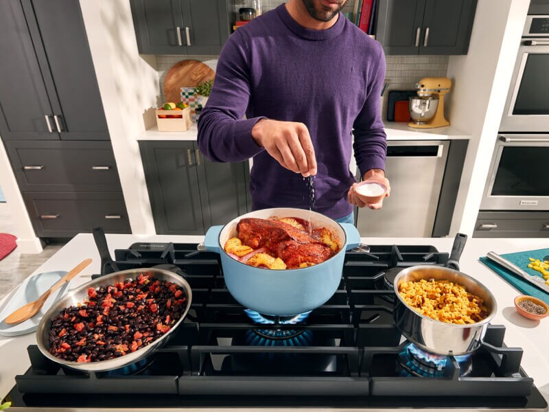 Person cooking on a gas range Person cooking on a gas range