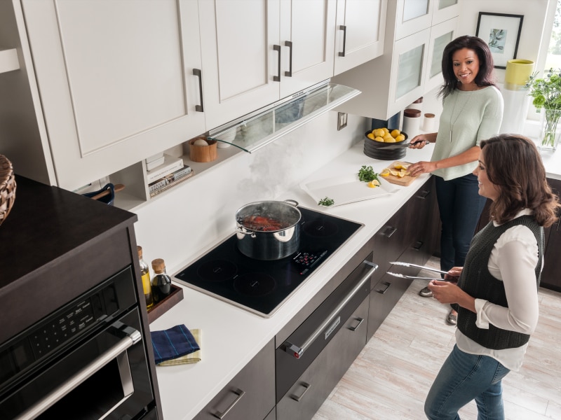 Two people cooking in the kitchen Two people cooking in the kitchen