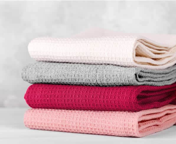 Different linens in shades of pink and gray.
