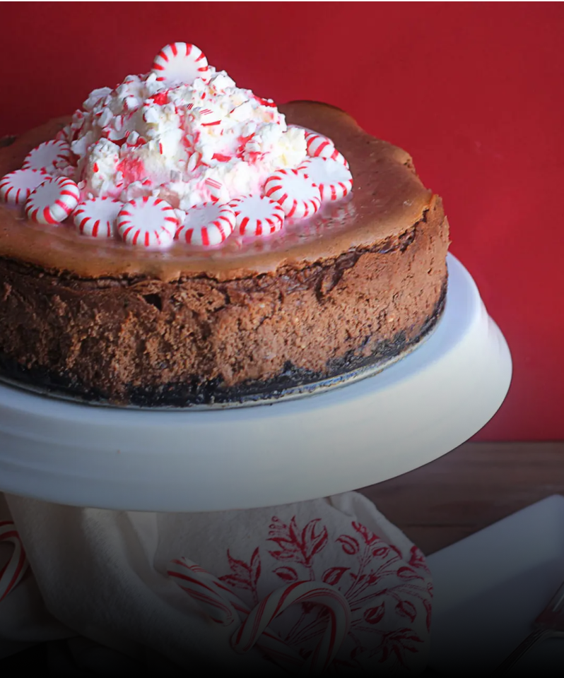 A chocolate cake with a pile of mints on top.
