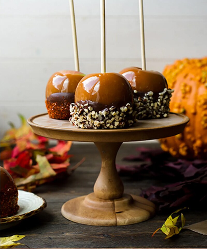 Caramel apples on a display.