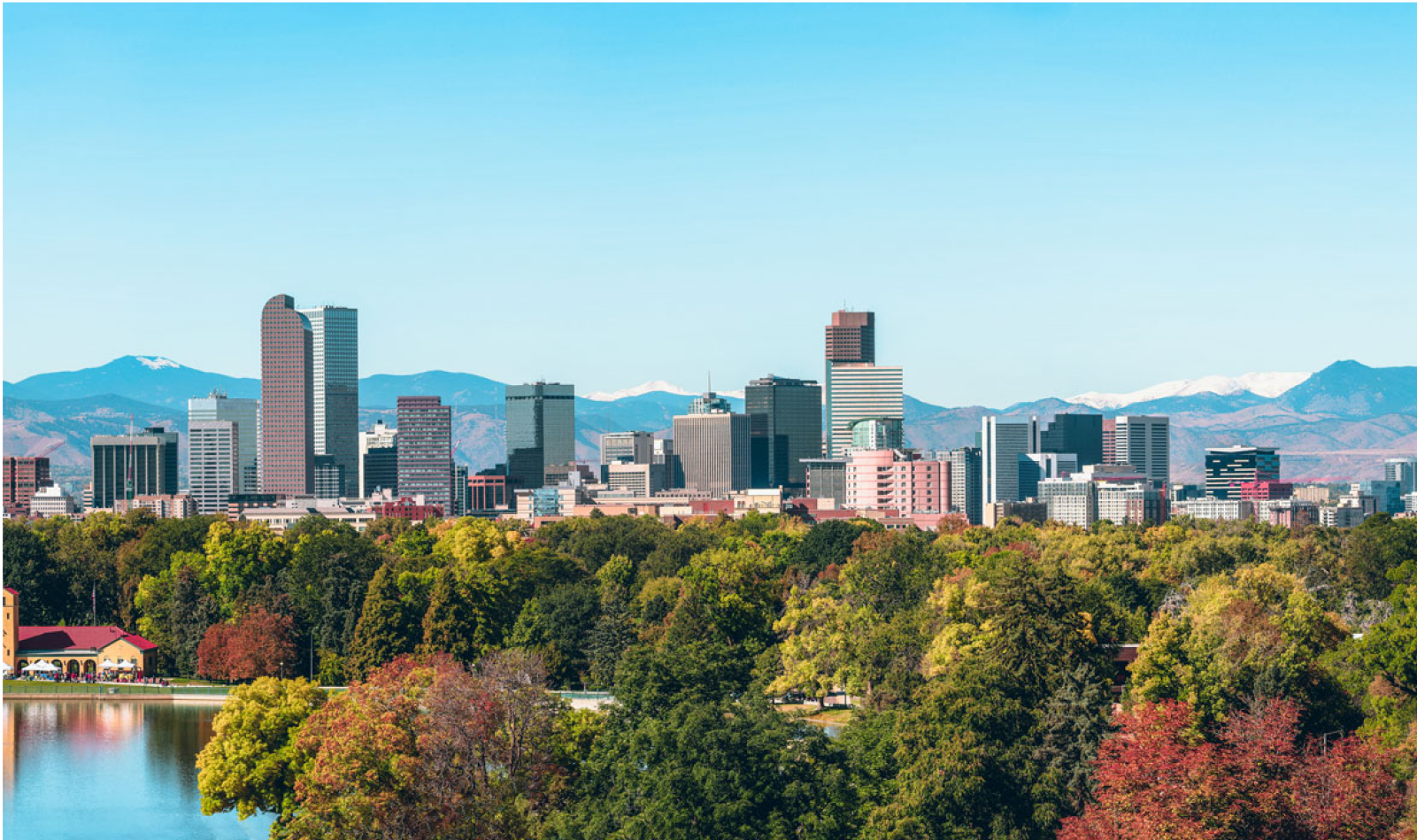 The city of Denver surrounded by picturesque mountains and colorful trees.
