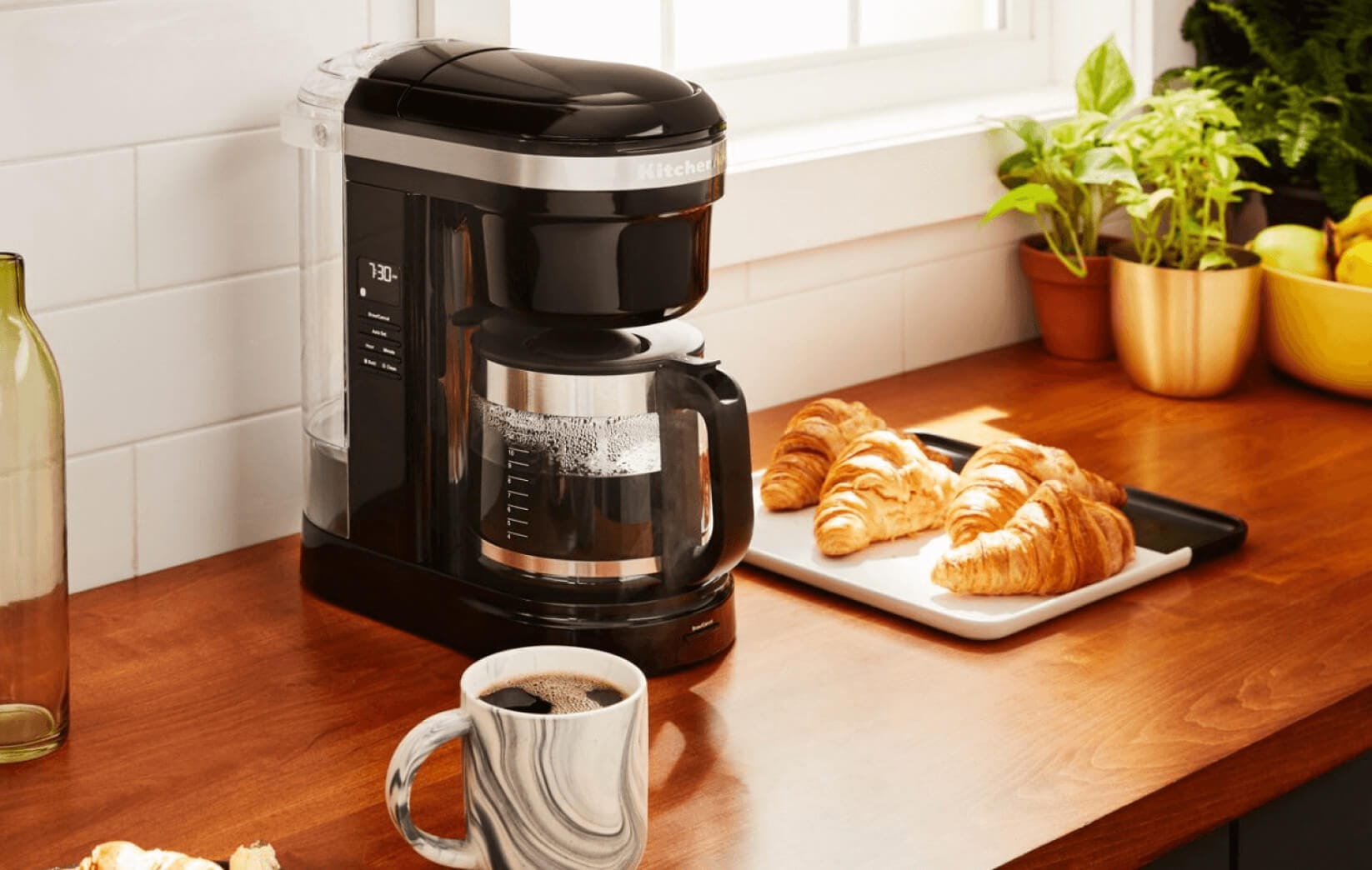 A KitchenAid® 12 Drip Coffee Maker holding freshly made coffee.