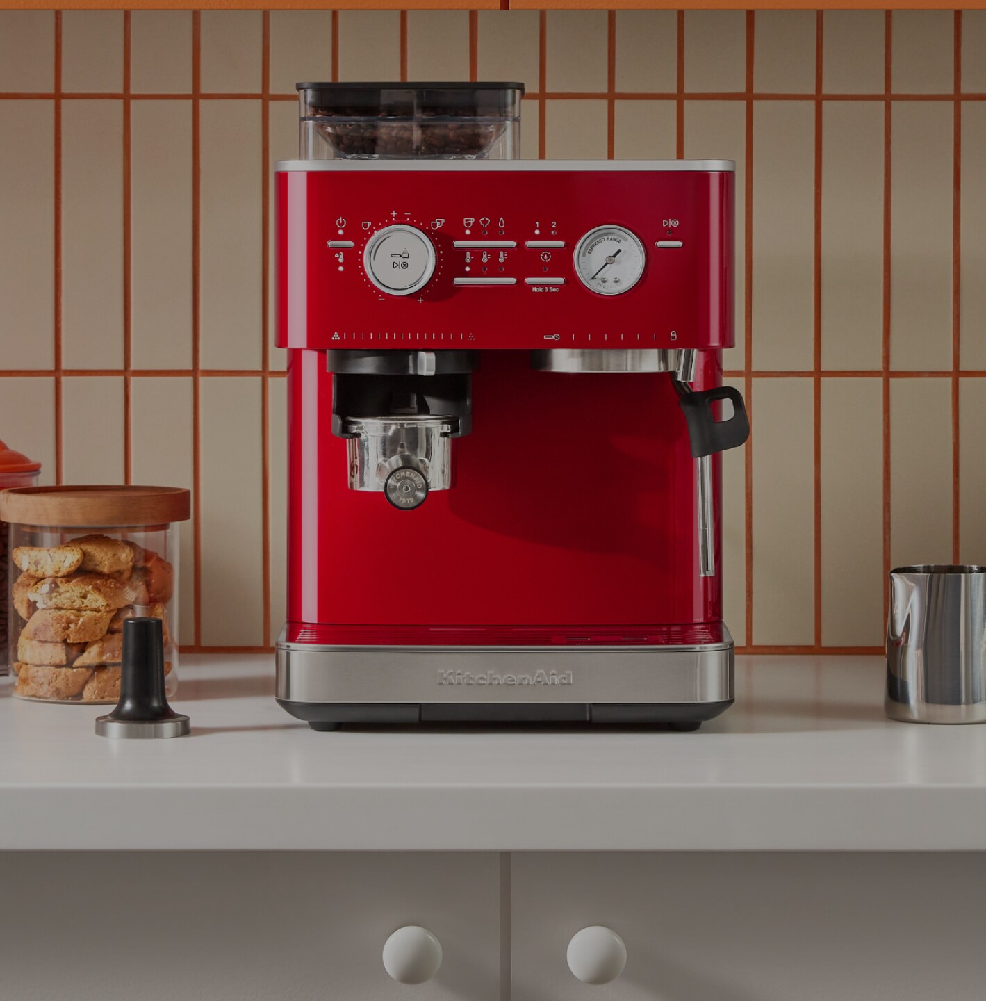 A red KitchenAid® semi-automatic espresso machine on a countertop. 