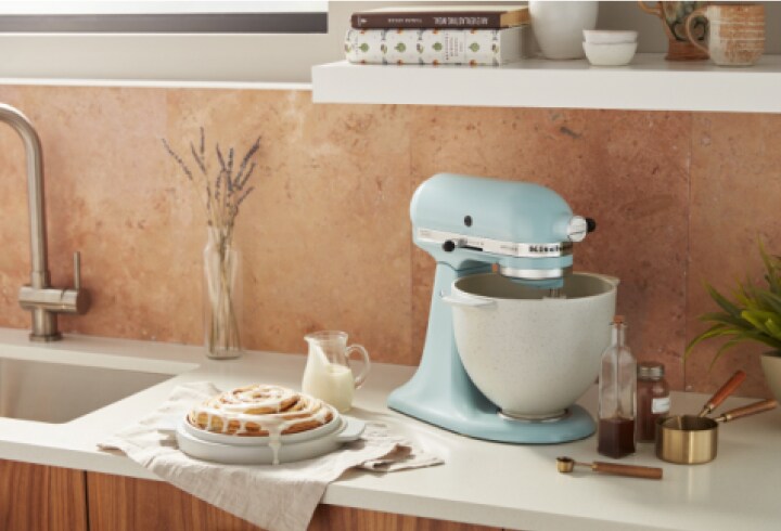 A light blue KitchenAid stand mixer on a countertop