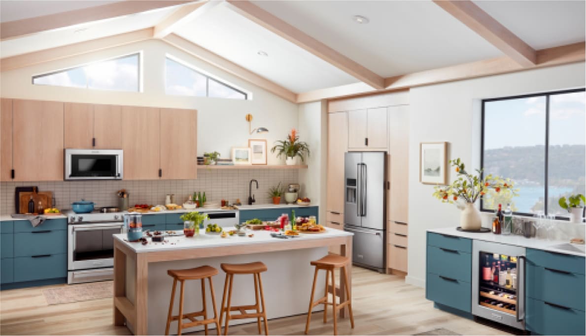 A bright, stylish kitchen outfitted with KitchenAid® appliances, plus teal and wood cabinets.