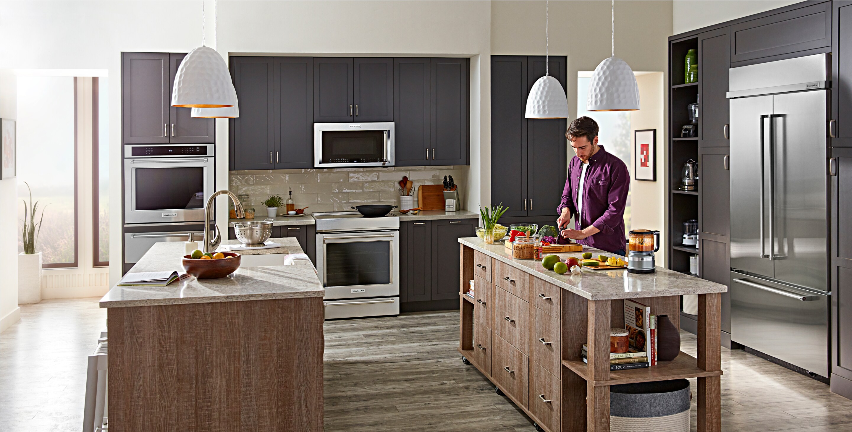 A large, open-concept kitchen filled with built-in KitchenAid® appliances. 