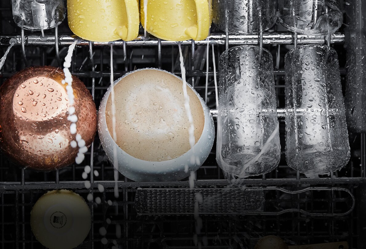 Water spraying on dishes in a KitchenAid® dishwasher,
