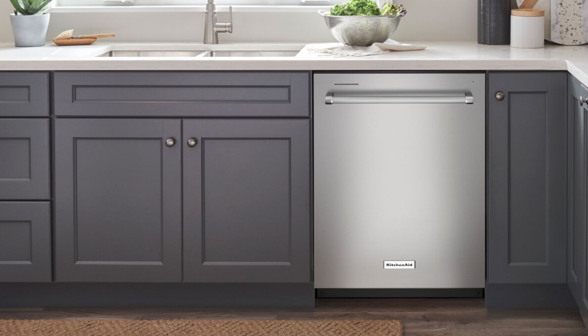 A dishwasher in a bank of cabinets