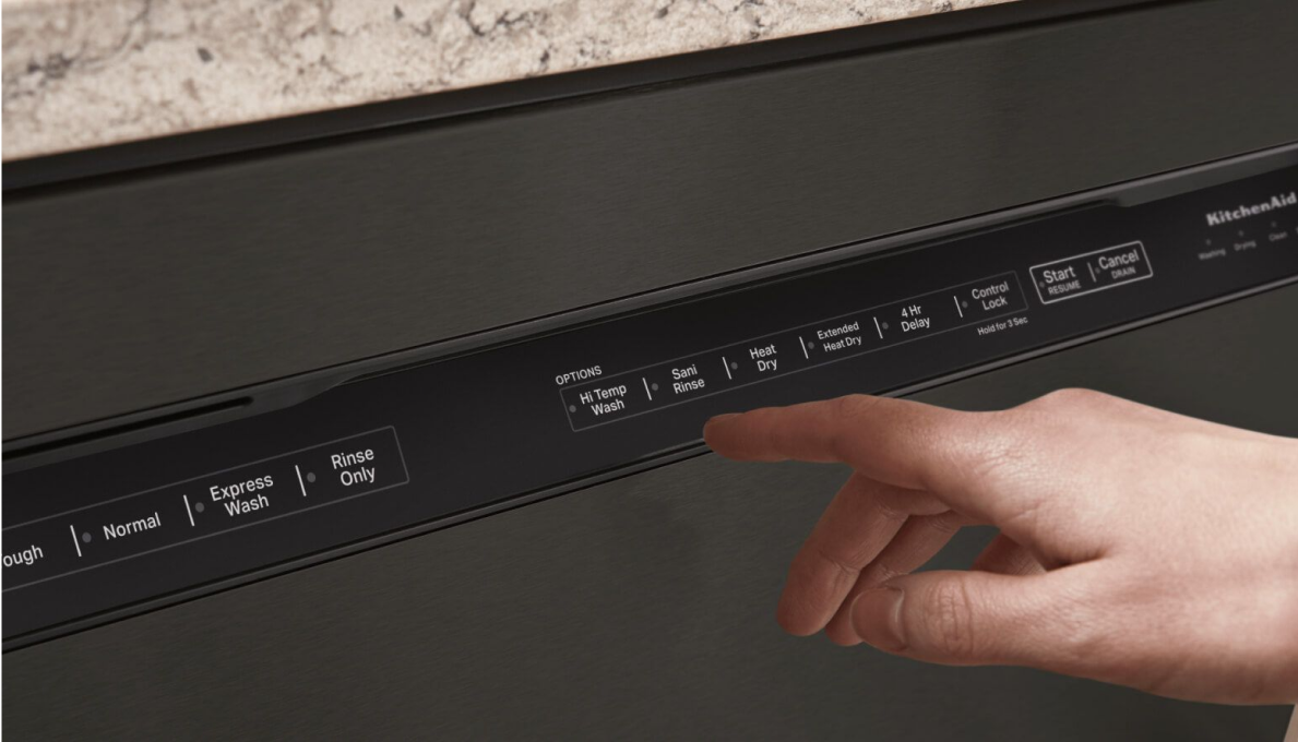 A person touching the control console of a dishwasher