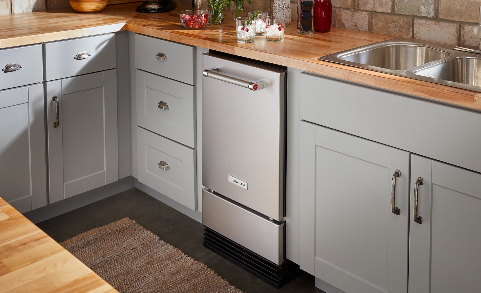 A KitchenAid® Ice Maker built into lower kitchen cabinets.