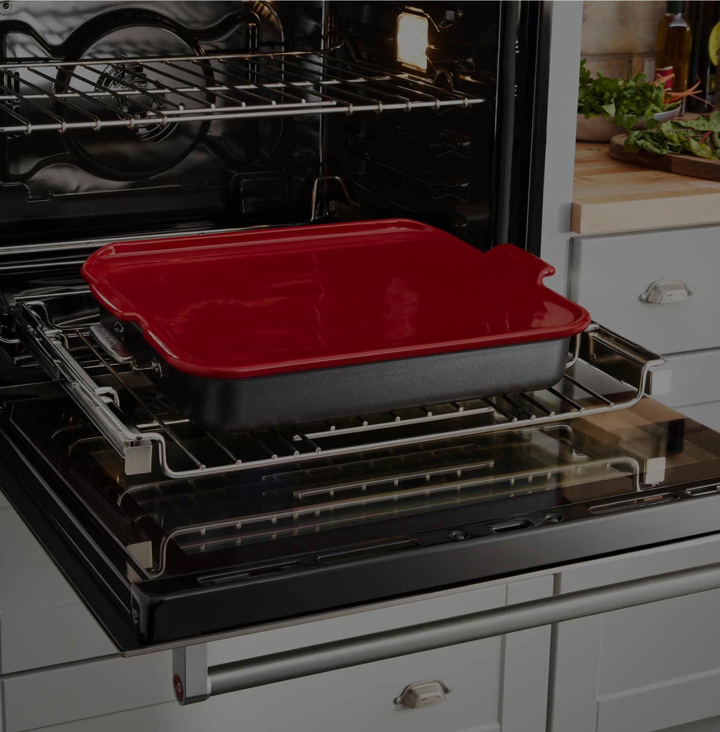An open Smart Oven+ wall oven with a pan of carrots.