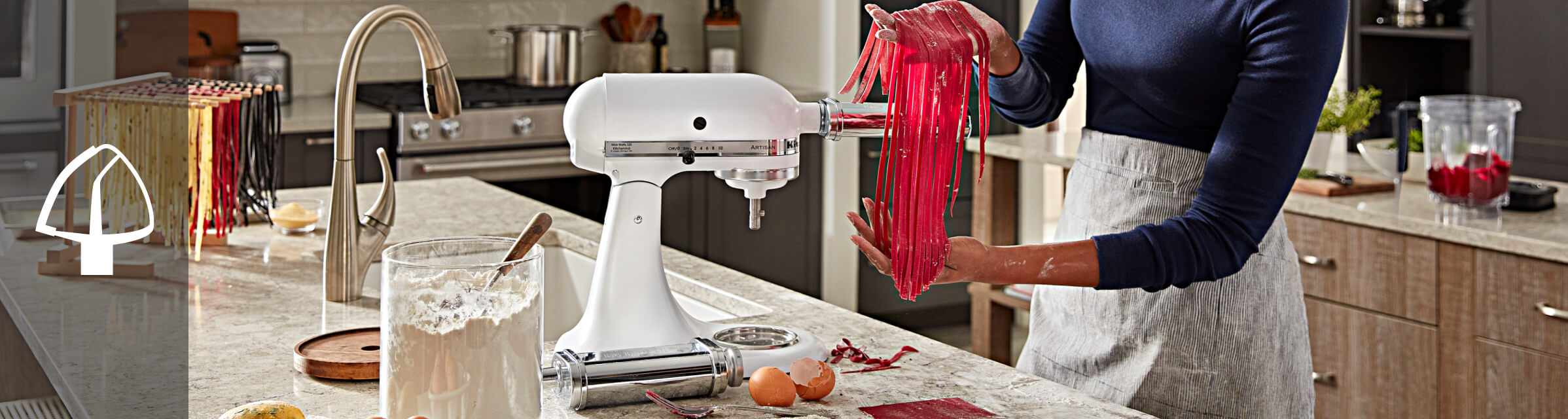 Person using a KitchenAid® pasta attachment Person using a KitchenAid® pasta attachment