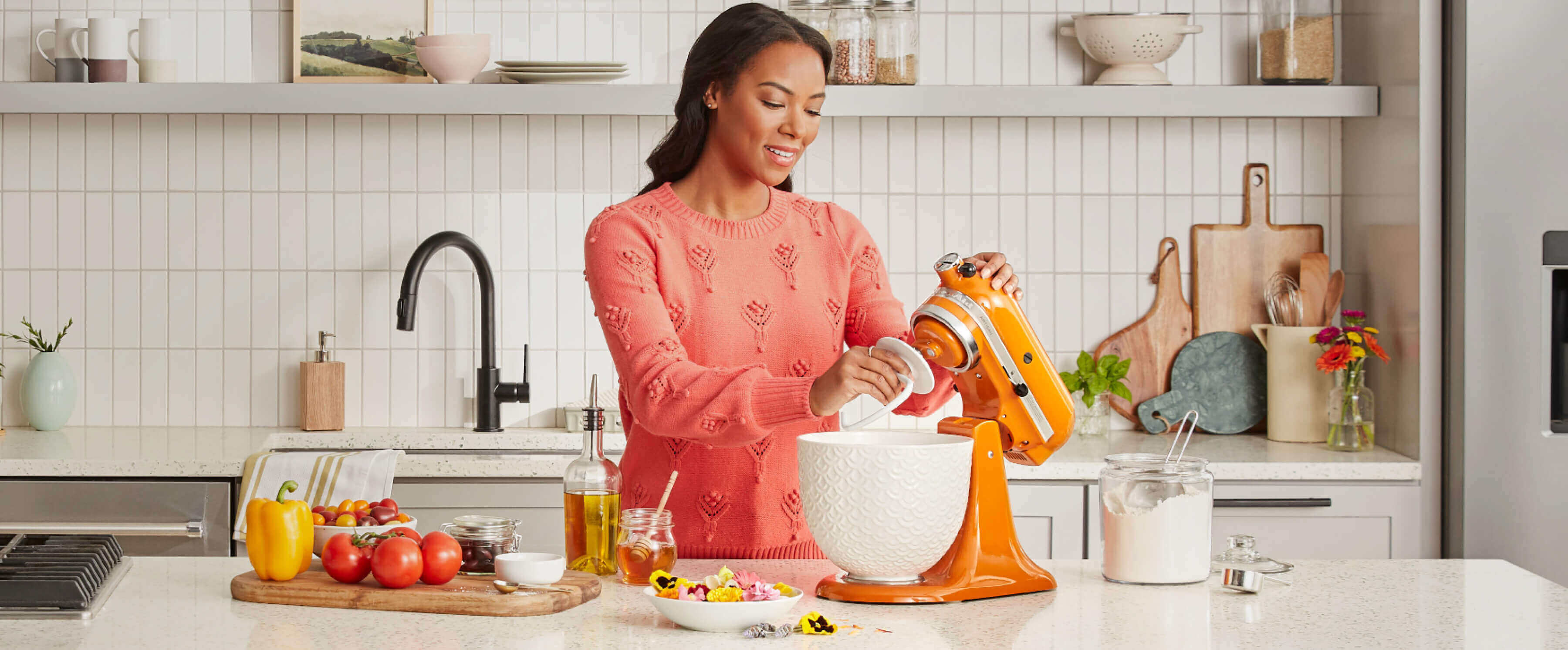 A person baking using a KitchenAid® stand mixer