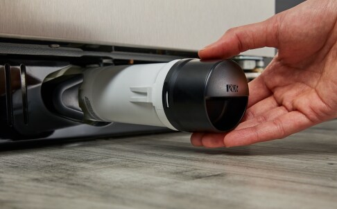 Inserting water filter into bottom grille