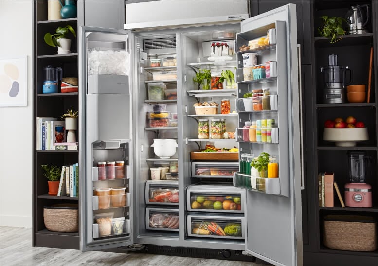 An open 48" KitchenAid® Built-In Side-by-Side Refrigerator KBSD708M filled with fresh produce and ingredients