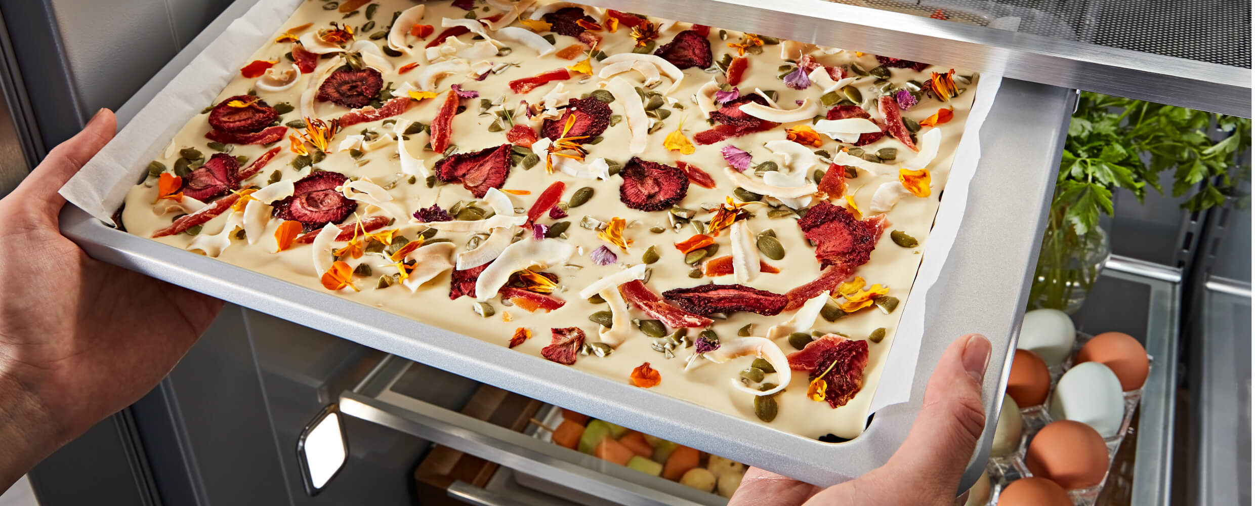 48" KitchenAid® Built-In Side-by-Side Refrigerator Under-Shelf Prep Zone holding a peach dessert