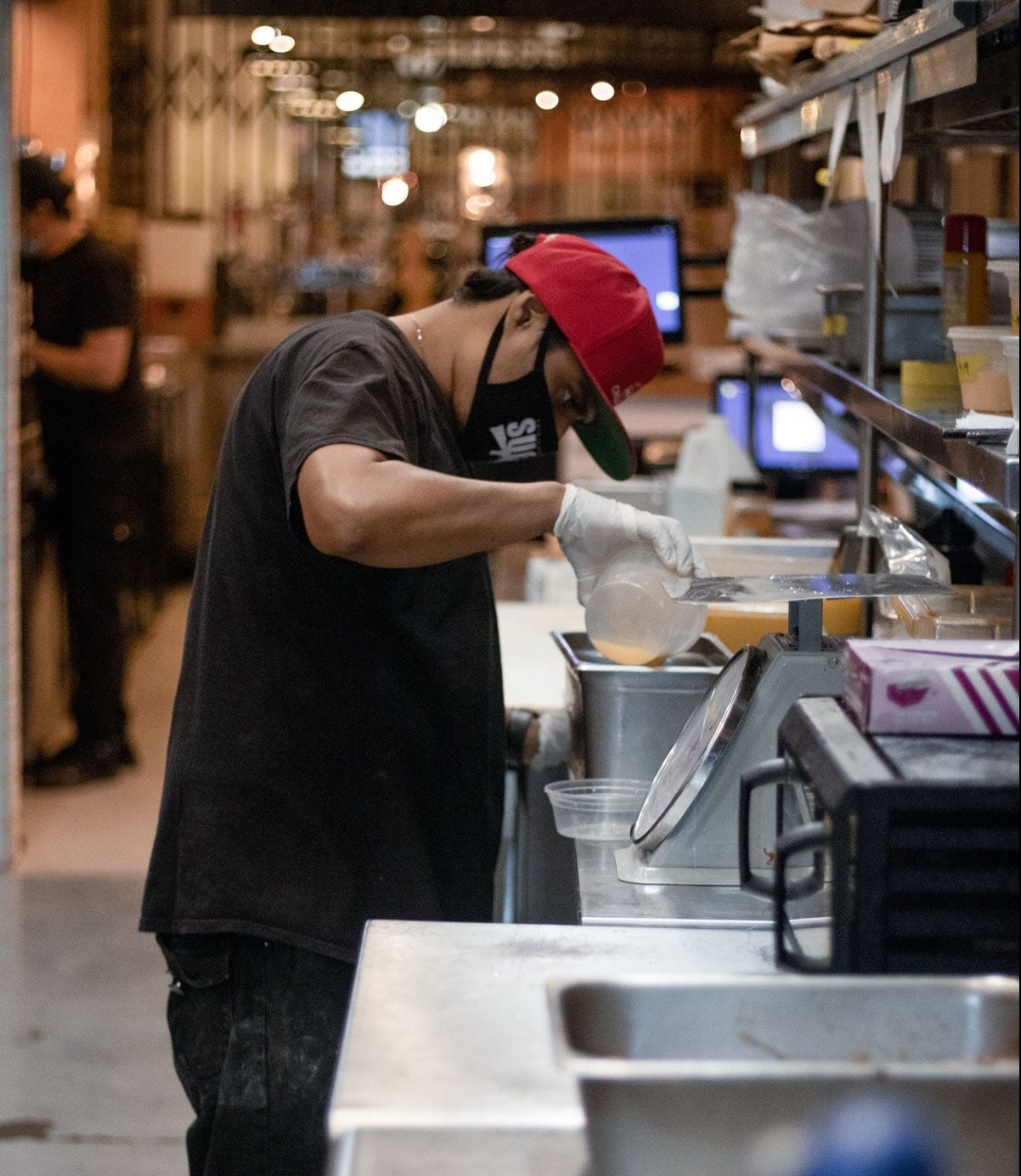 A person diligently prepping in in the Pulkies kitchen.