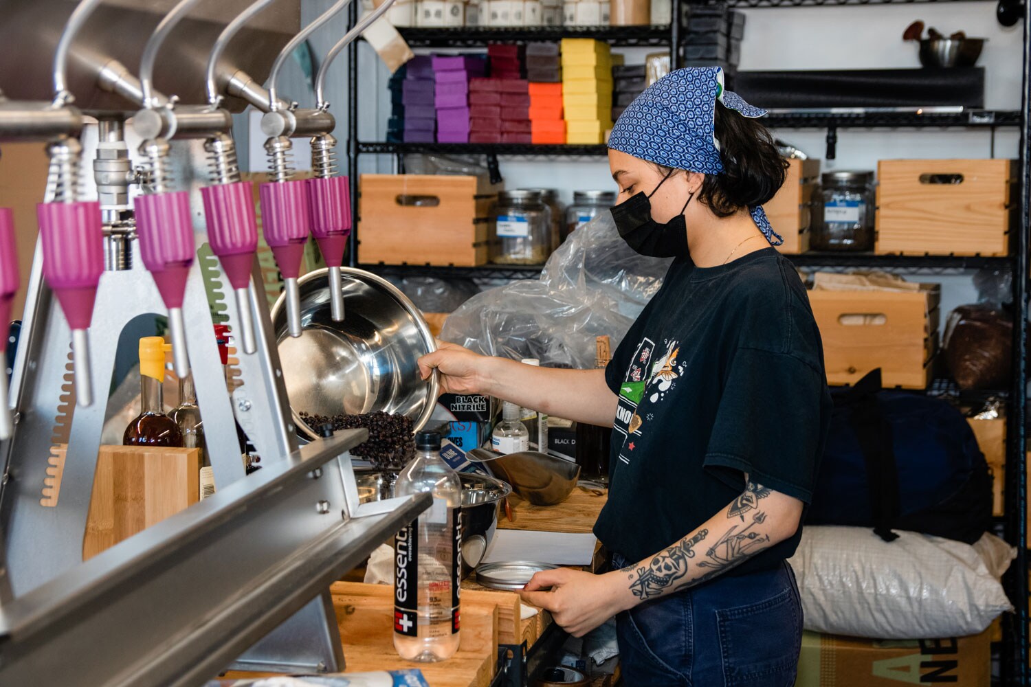 A person sorting herbs into a larger bowl.