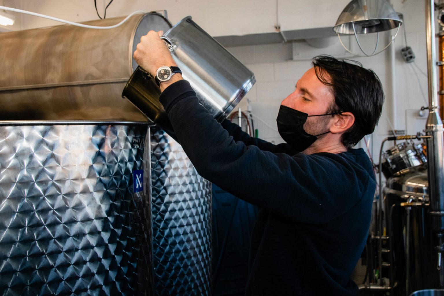 Daniel de la Nuez pouring a large pot into a larger pot.