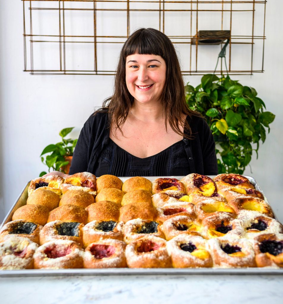 Autumn Stanford holding a tray of kolaches.