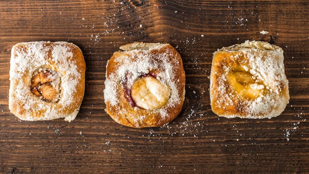 Kolaches topped with powdered sugar.