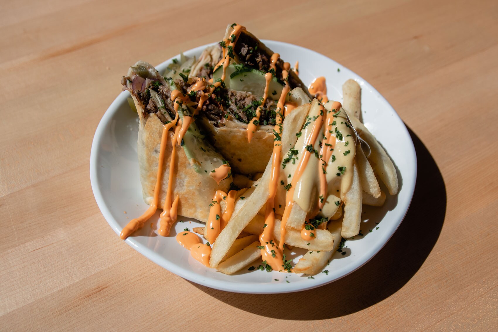 A plate of gyro and french fries.