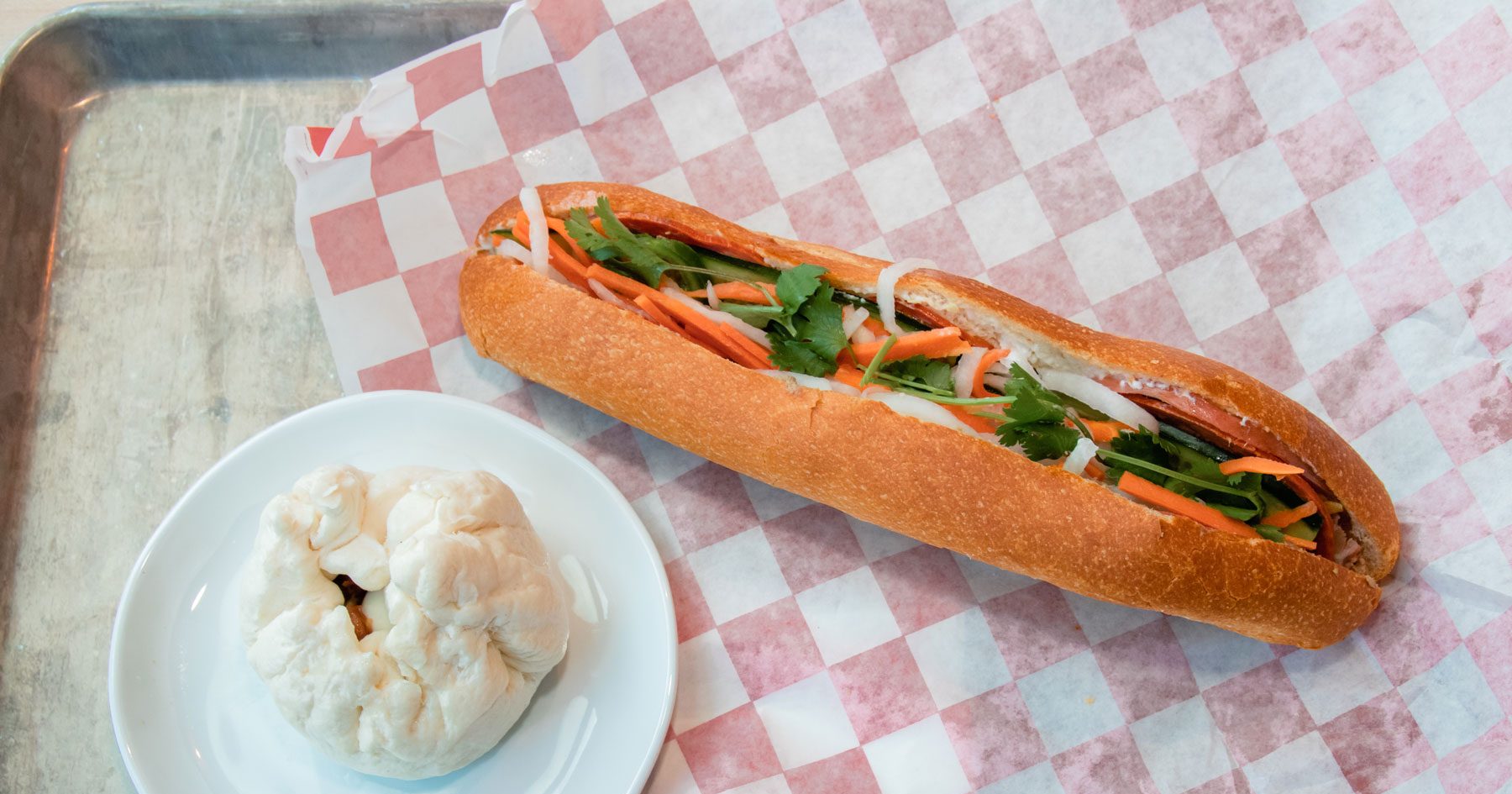 A large sandwich overflowing with its contents.