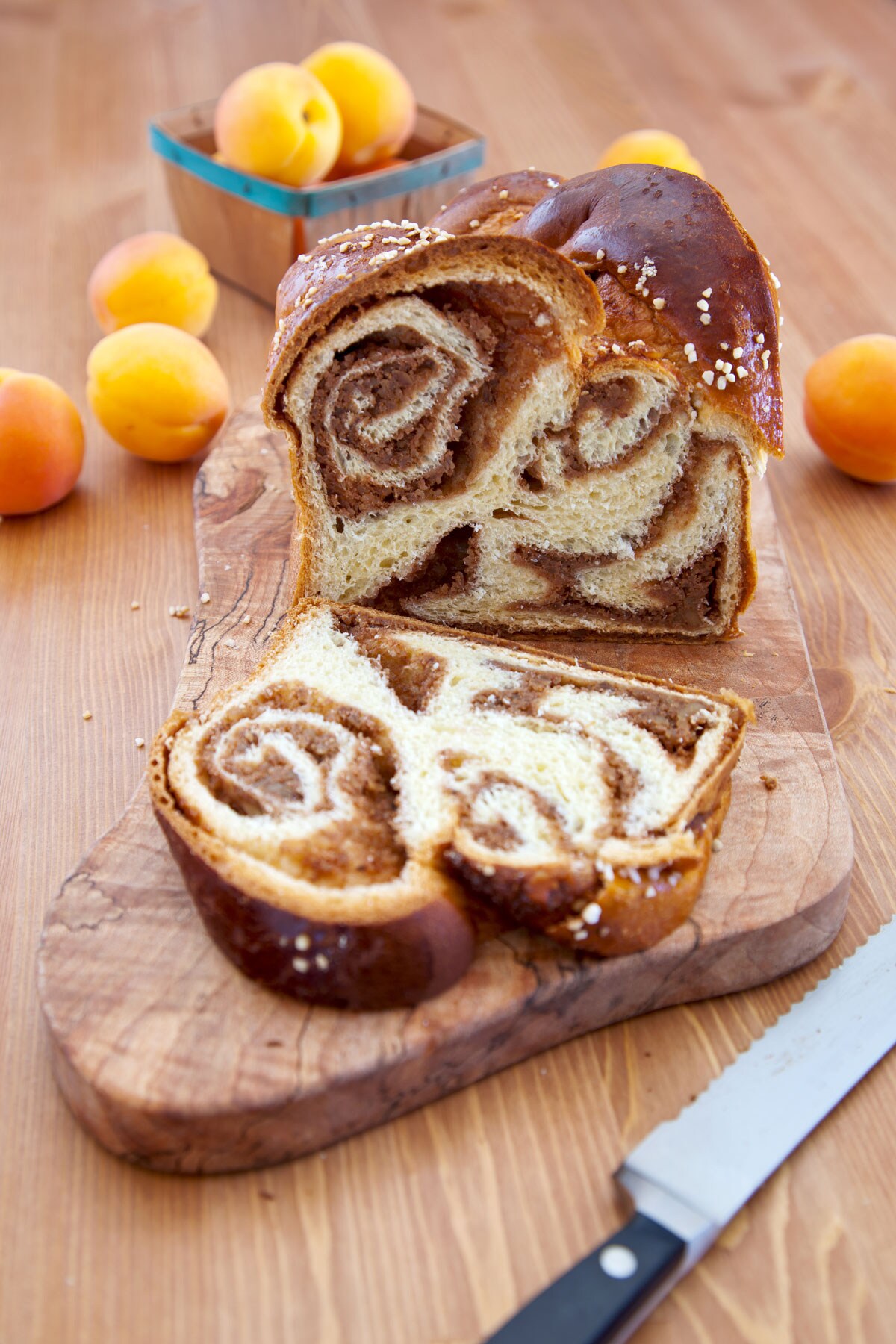 A slice of cinnamon babka bread resting on a wooden cutting board.