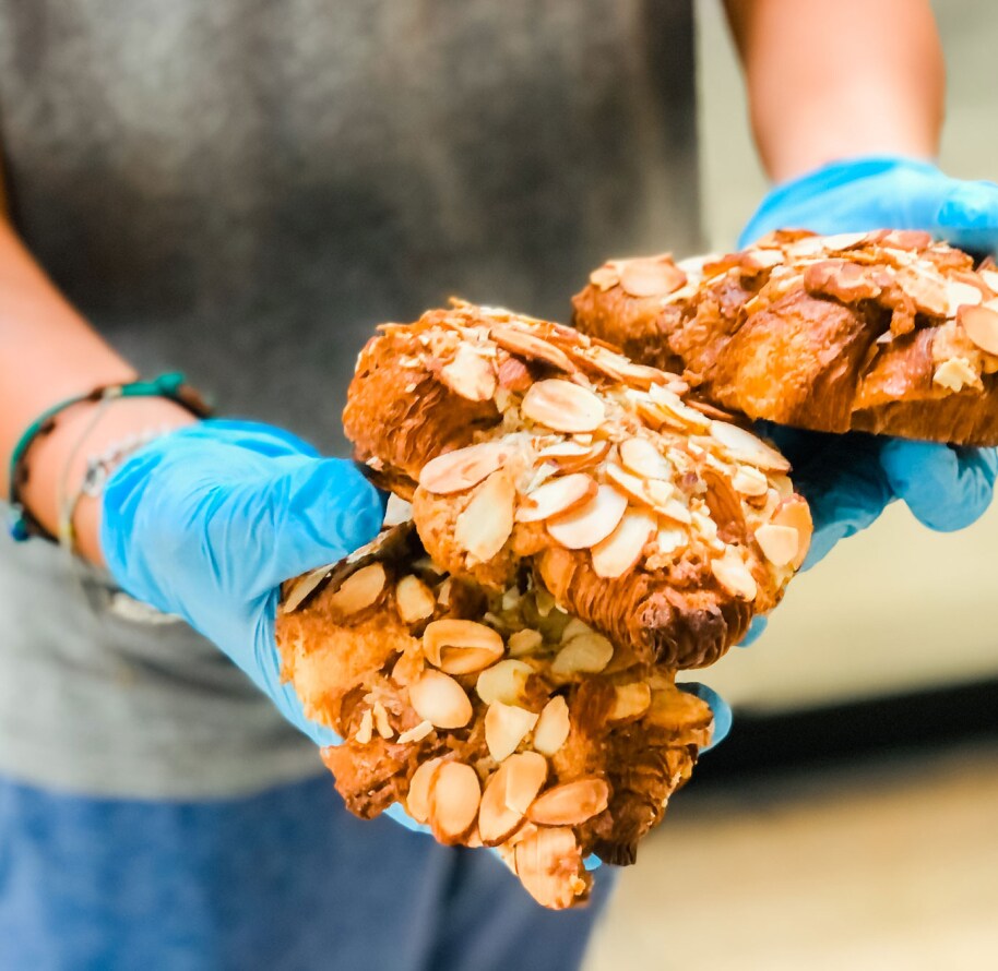 A person holding baked goods from Clark Street Bakery.