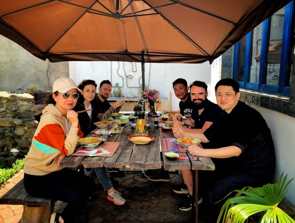 People eating outside at a large table.