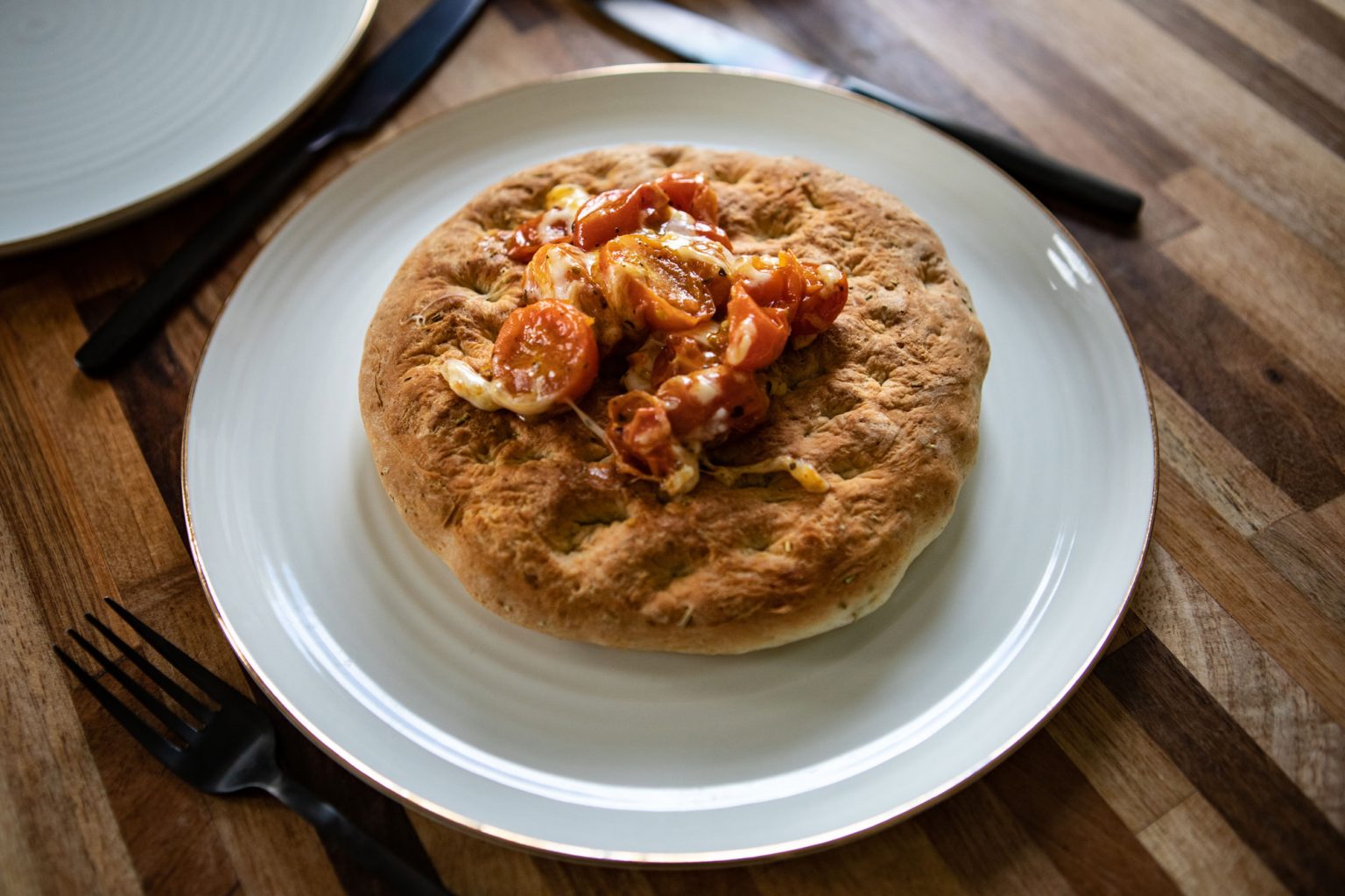 A plated, freshly made focaccia bread.