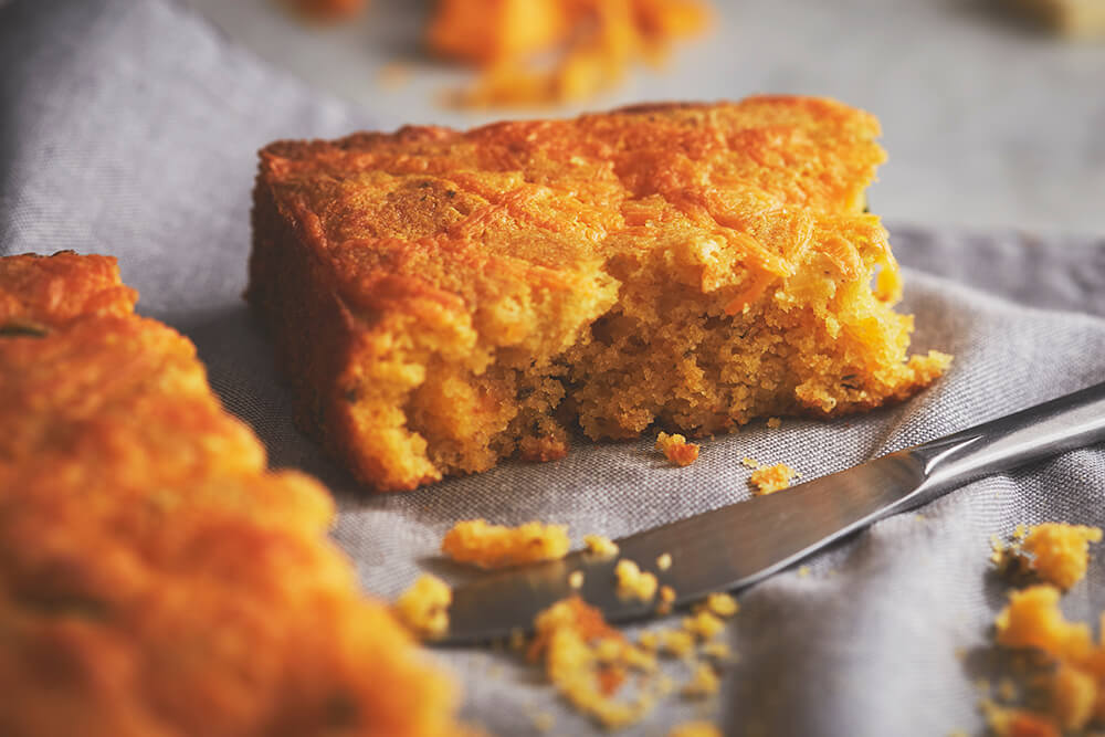 A slice of cornbread resting on a cloth napkin.