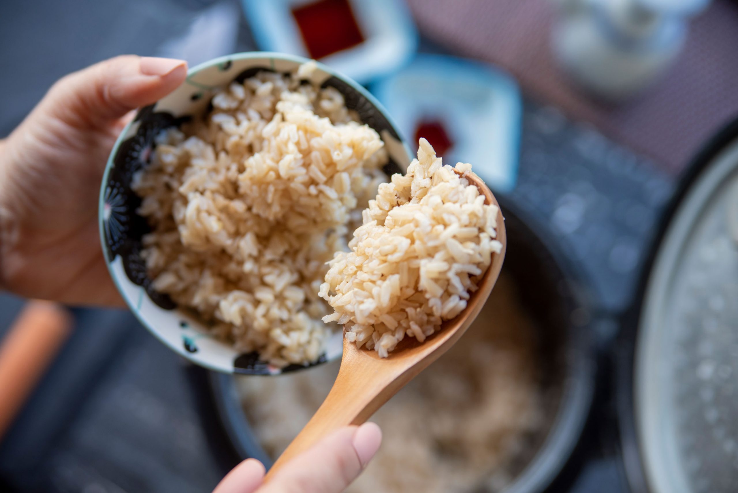 A white bowl with intricate blue detailing filled with cooked rice.
