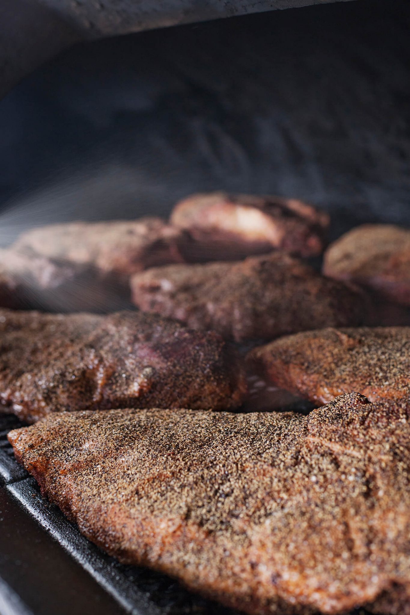 Cooked meat resting inside a cast iron grill.