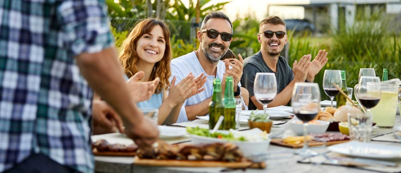 People applauding their cook.