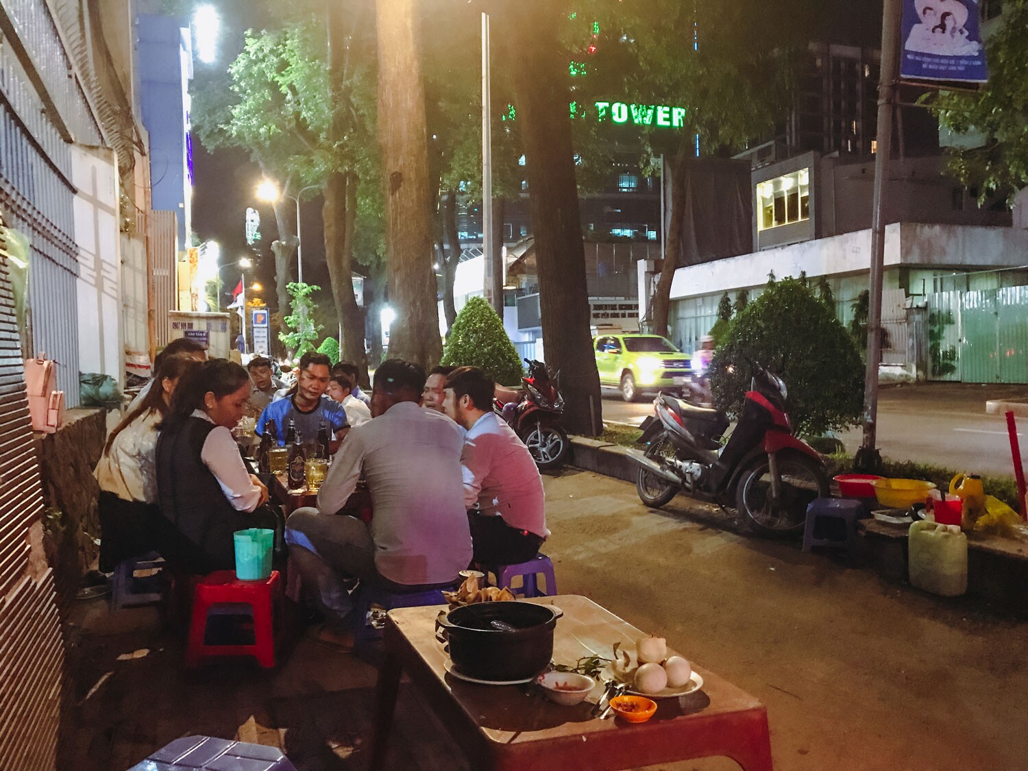 People sitting outside eating their food and socializing.