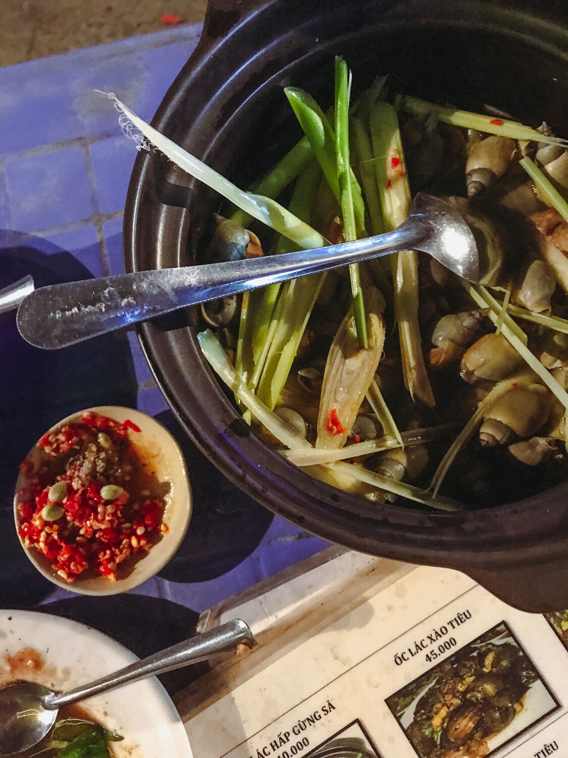 A bowl of sea snails steamed with ginger and lemongrass.