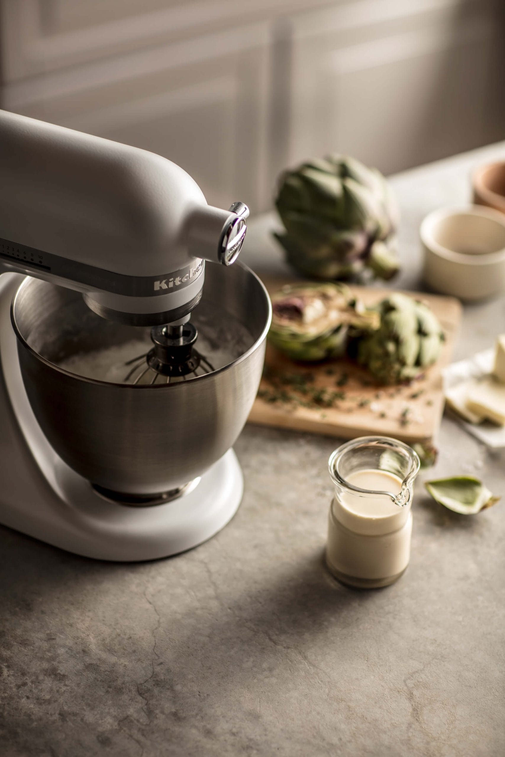 A KitchenAid® Stand Mixer mixing away on a kitchen countertop.
