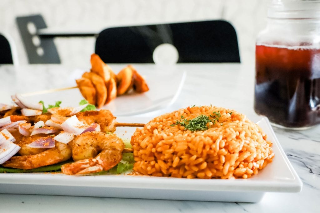 A plate of rice and grilled shrimps.