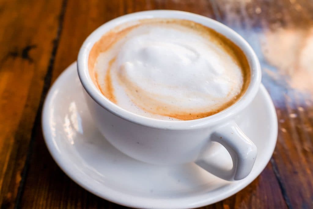 A chai tea latte in a tea cup.
